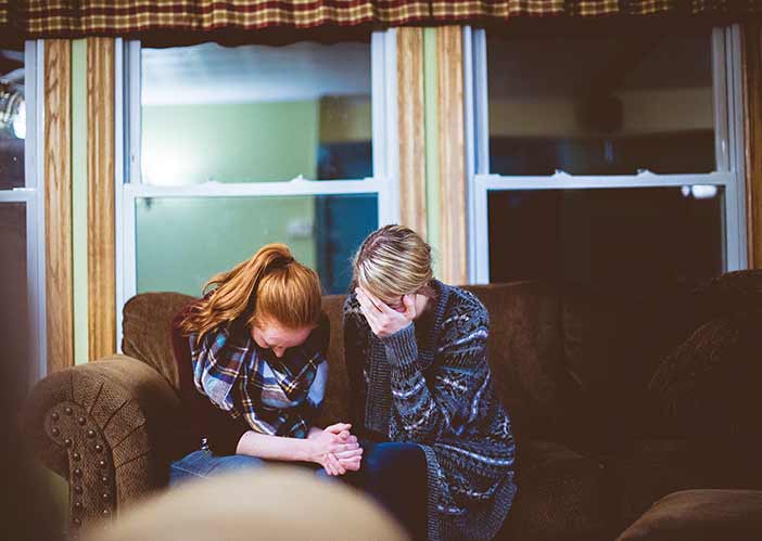 20171107-our-region-bodyimage-two-women-praying-together-couch