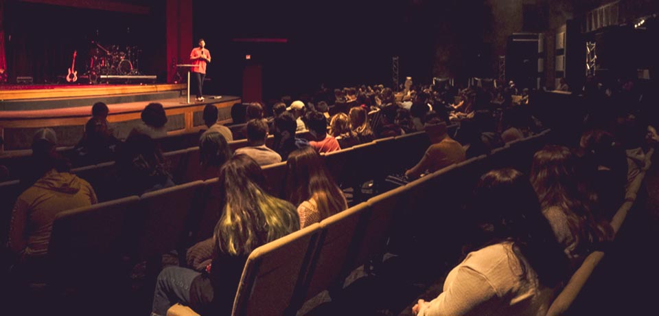 Middle school kids listening to a speaker